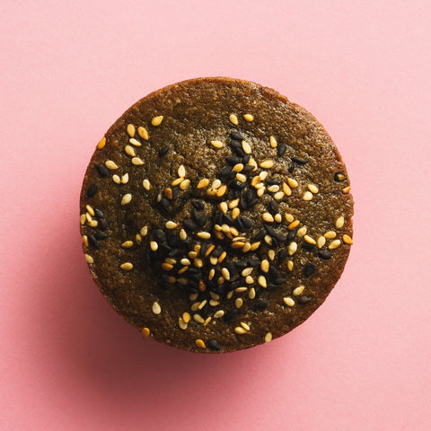 Black sesame butter mochi birdseye view pink background