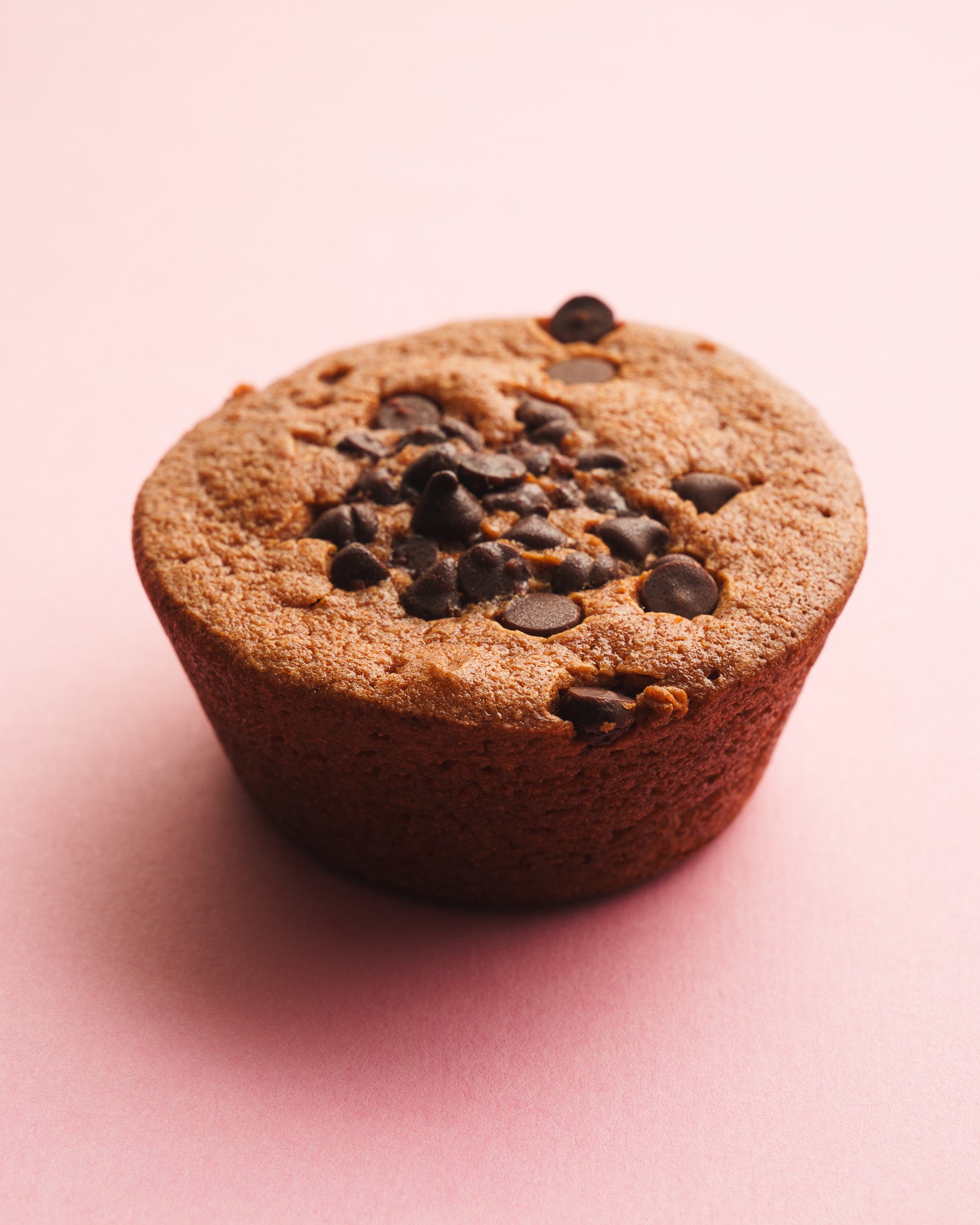 Chocolate butter mochi three quarter view pink background