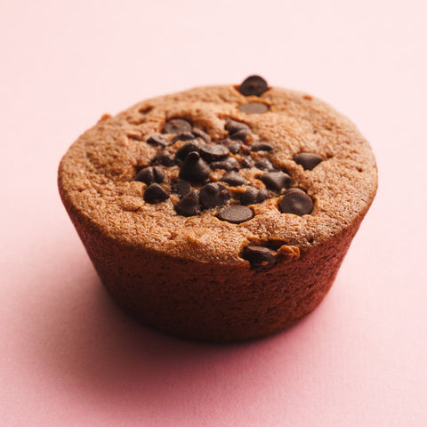 Chocolate butter mochi three quarter view pink background