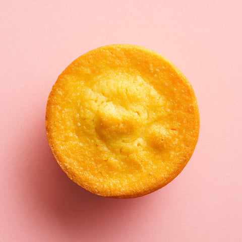 Classic butter mochi birdseye view pink background