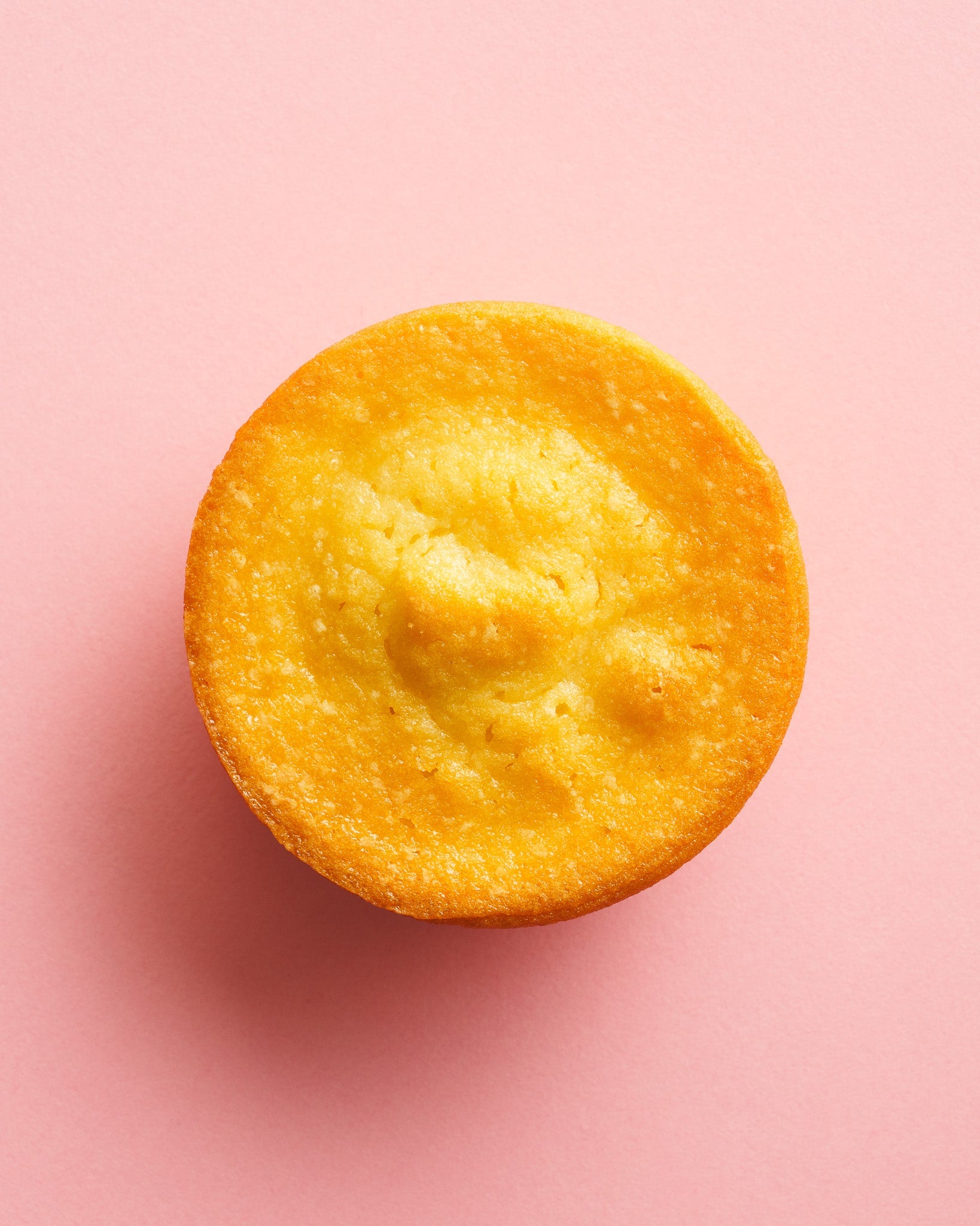 Classic butter mochi birdseye view pink background