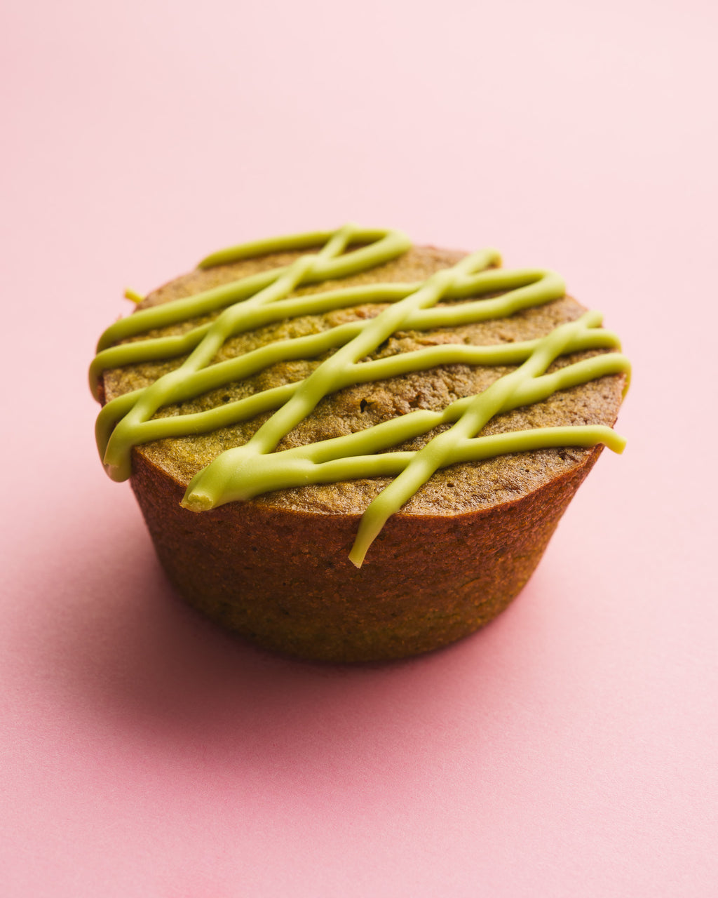 Matcha butter mochi three quarter view pink background