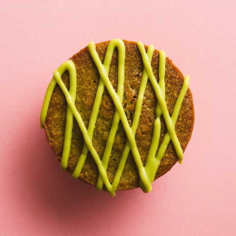 Matcha butter mochi birdseye view pink background