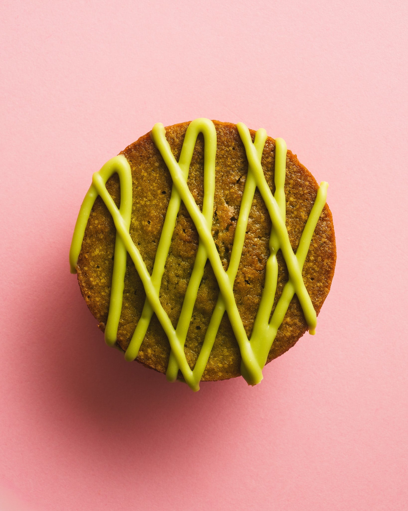 Matcha butter mochi birdseye view pink background