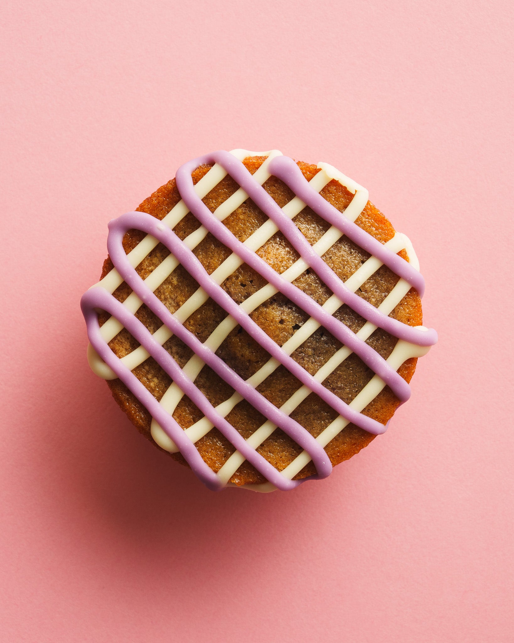 Ube butter mochi birdseye view pink background