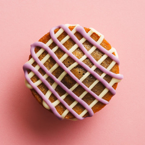 Ube butter mochi birdseye view pink background