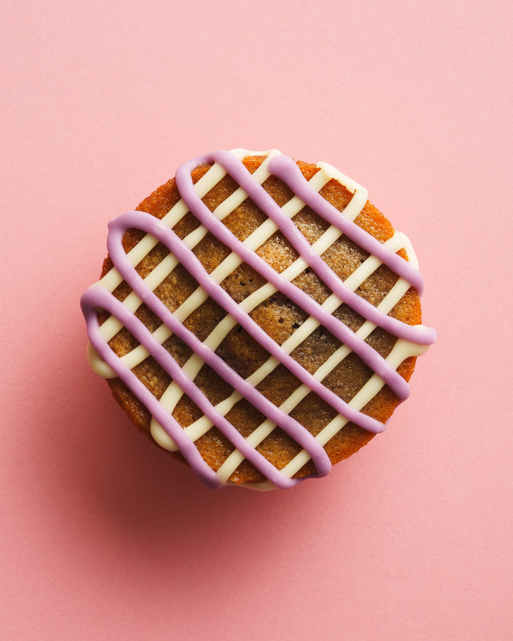 Ube butter mochi birdseye view pink background
